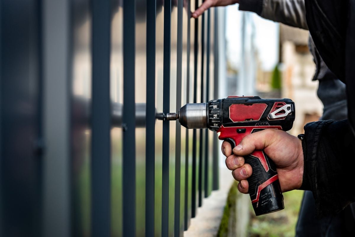 fence installation worker hand